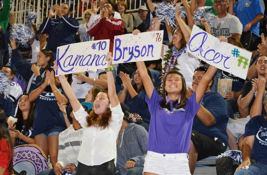 Kaelyn Nakamura-Kowalski and Victoria Alakai cheer on their fellow classmates at the Homecoming game on Oct. 19 at Kanaʻiaupuni Stadium.