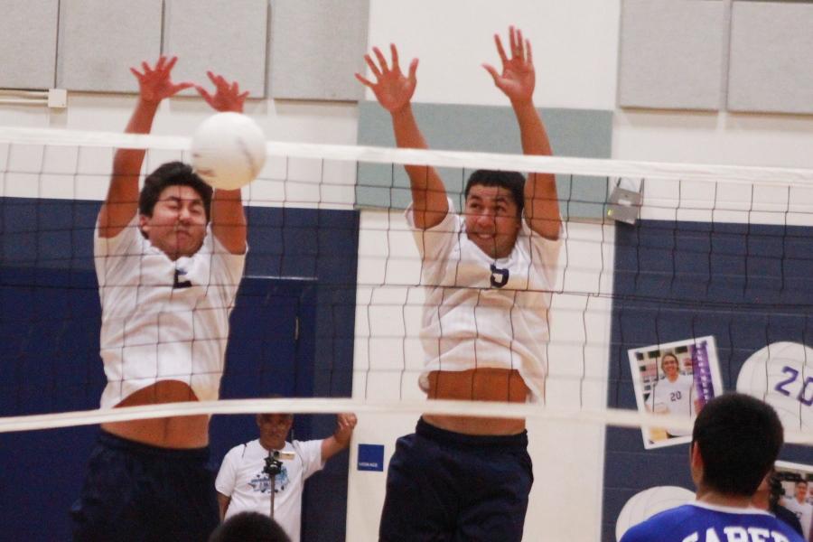 Kekoa Uyechi and Mana Aikala block against a hit by the Maui High Sabers on April 23, 2013. The Warriors lost in four sets on their senior night.