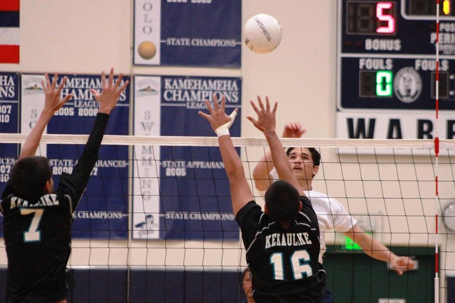 Senior RJ Moku hits over the KKHS Nā Aliʻi on April 4, 2013. The Warriors won in all three sets, keeping a fair lead on the Nā Aliʻi for the most of the game.