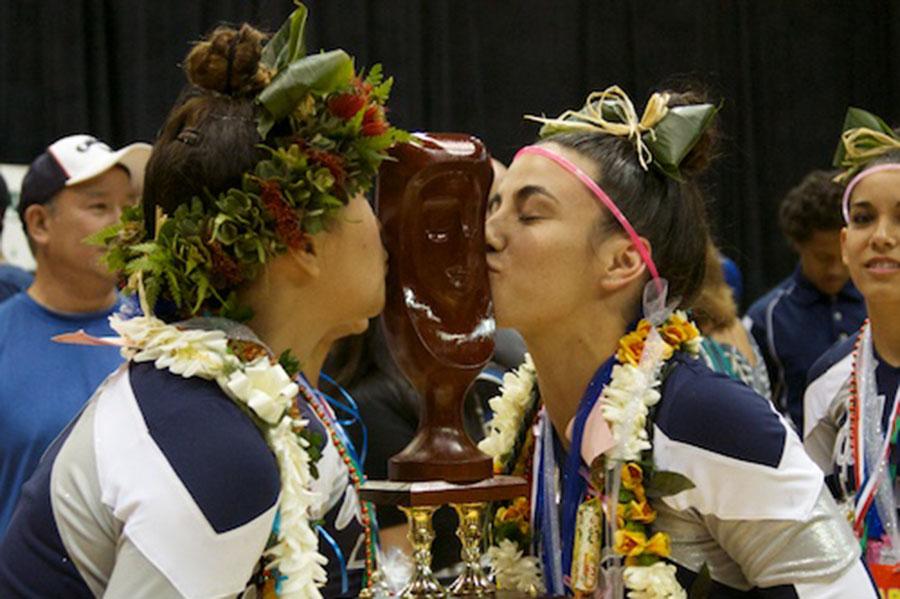 Juniors Rachel Kaulupali and Moana Astronomo kiss the trophy after the award ceremony.