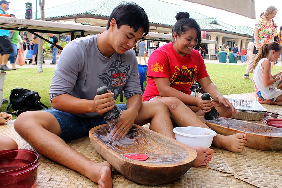 Elijah Won and Kamaile Pahukoa pound kalo into poi during the 10th Annual Hoʻolauleʻa today, May 3, 2014, at the Kamehameha Schools Maui Campus.