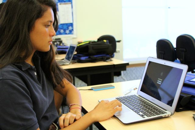 Senior Brandy Takiguchi waits patiently as she creates her Apple ID for her new Mac laptop. All students received brand new devices through the schoolwide PC to Mac switch this year. Today, August 4, 2014, was the first day of school at KS Maui for the 2014-15 school year.