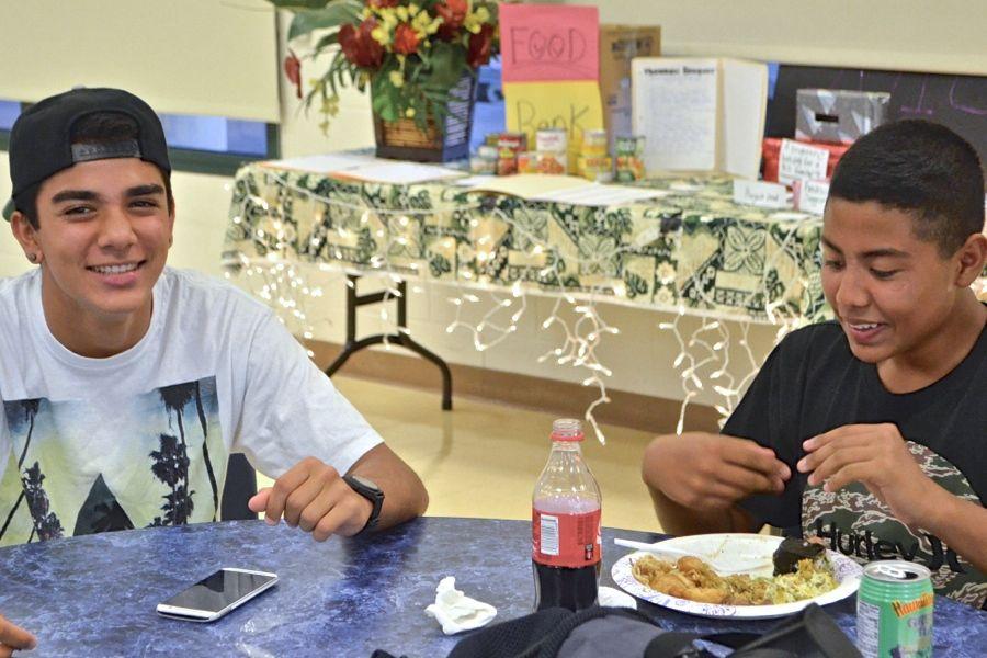 Freshmen Keoni Rosete and Kaleo-David Deguilmo are thankful for the good food and time with friends at the freshman Thanksgiving banquet on Saturday, Nov. 22.