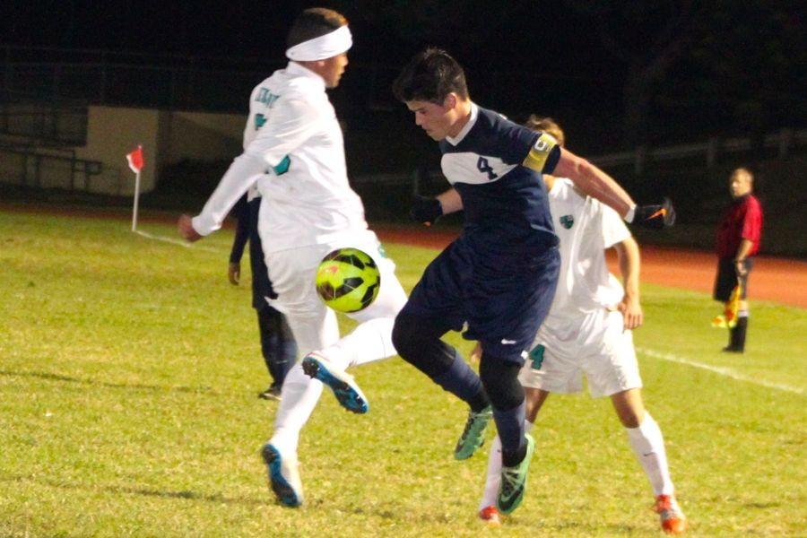 Senior Micah Alo (4) wins the ball mid-air in Wednesdayʻs game against King Kekaulike. The Warriors tied, 2-2, and brought their season standing so far to 3-0-1.