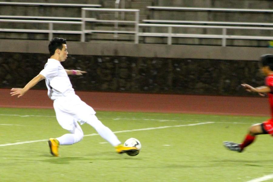 Brennan Joaquin avoids a defender in last nights game against Lahainaluna High School. The Warriors trailed in the first half, but won 5-2.