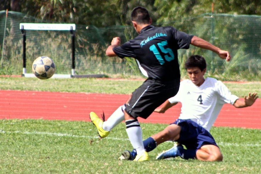 Freshman Hinano Long (4) attempts to slide tackle the ball away from a Nā Aliʻi player in the second game of the day. The Kamehameha Maui junior varsity boys went 1-1 in the double header against the Bears and Nā Aliʻi at King Kekaulike High School.