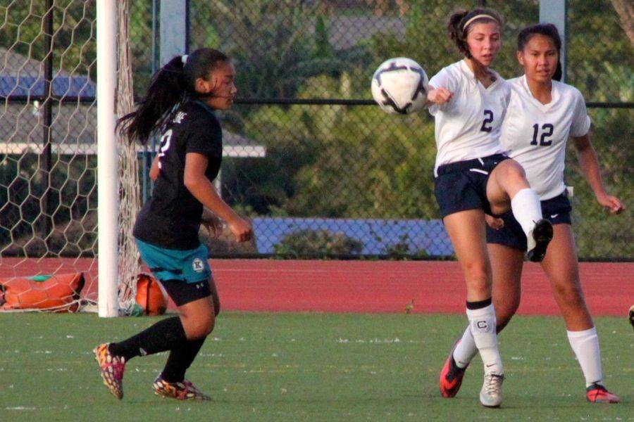 Senior Kehaulani Macadangdang (2) clears the ball away from the Warrior net. In a do-or-die game last night, January 30, Kamehameha Maui pulled out a win over the King Kekaulike and kept alive hopes of both a shot at the league title and trip to the state tournament.