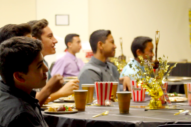 Blayde Demello watches the slide show at the Freshman Banquet Hollywood Style on January 31, 2015 at Keʻeaumokupāpaʻiaheahe Dining Hall.