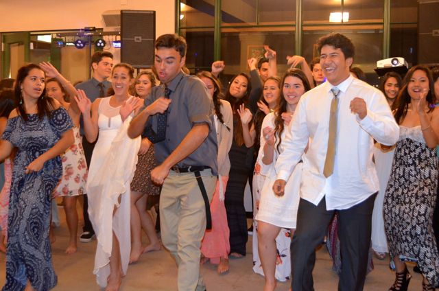 Kristian Gilliland and Ionatana Tua lead the way in the Electric Boogie by Marcia Griffith at the Senior Ball held at Keōpūolani Hale, March 14, 2015.