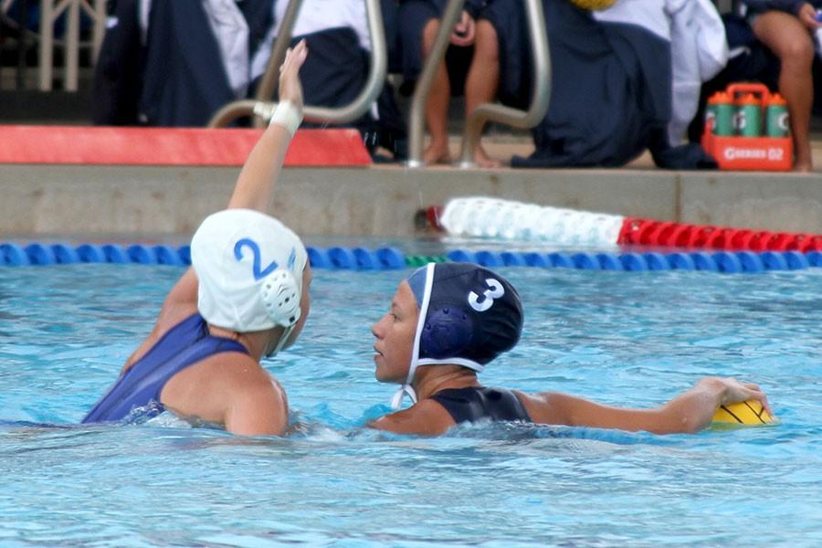 Senior Mia Czerwinski protects the ball as she prepares to pass during the Sabers 11-12 win over the Warriors on Tuesday, April 14, 2015, at Piʻilani Aquatic Center.