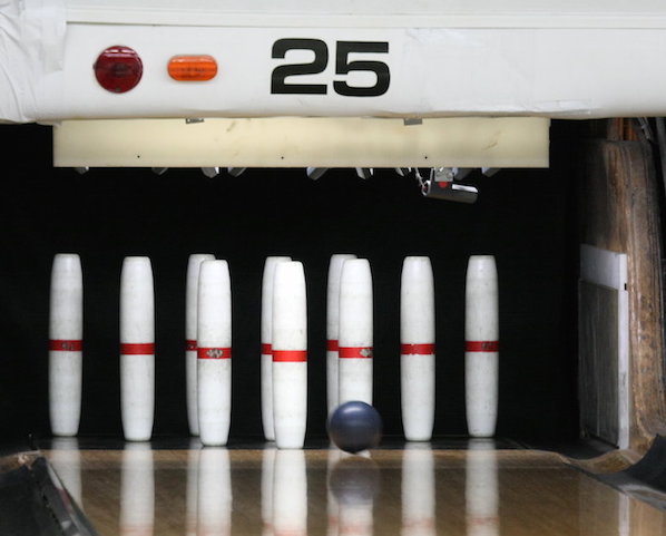 Candlepin bowling is a nine-pin variant of the standard ten-pin bowling we use in America. Candlepin bowling is used mainly in New England. 
