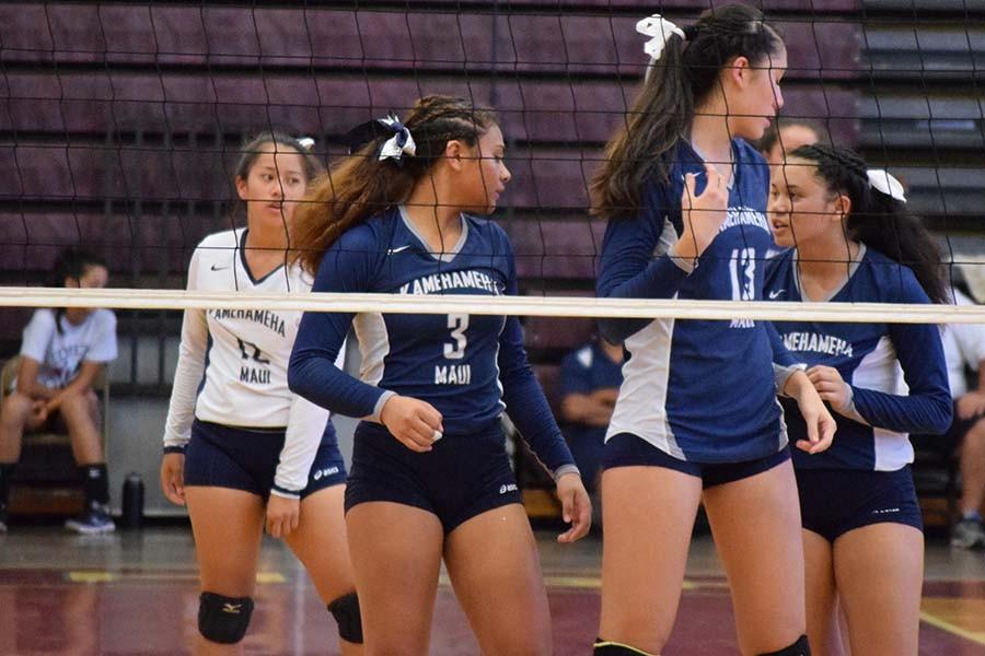 Kylee (Kaala) Corpuz (12), Selai Damuni (3) and Kylee Yamashita (13) as Lana Chong Kee communicates with them between serves at their match against Baldwin High School on Friday, August 28. The Kamehameha girls came out on top by winning all three sets.