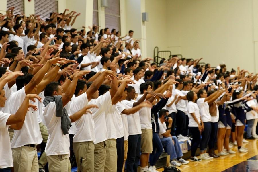 Everyone demonstrates the new blocking cheer--paku--to be used at volleyball. Students learned this and other Hawaiian language cheers at the homecoming pep rally, Sept. 18, in Kaulaheanuiokamoku gym.