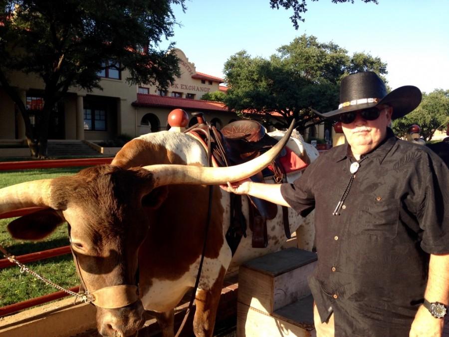 Kumu Kern and his wife love to travel. Here he is posing with a longhorn during a trip to Texas.