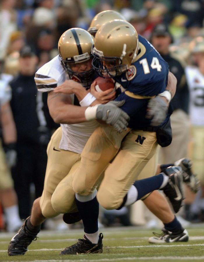 A football player makes a helmet to helmet tackle during a college football game between Army and Navy at M&T Bank Stadium in Baltimore on Dec. 1, 2007. In 2010, the NFL enforced the helmet to helmet contact rules to preven injuries such as concussion which can result from these kind of hits.