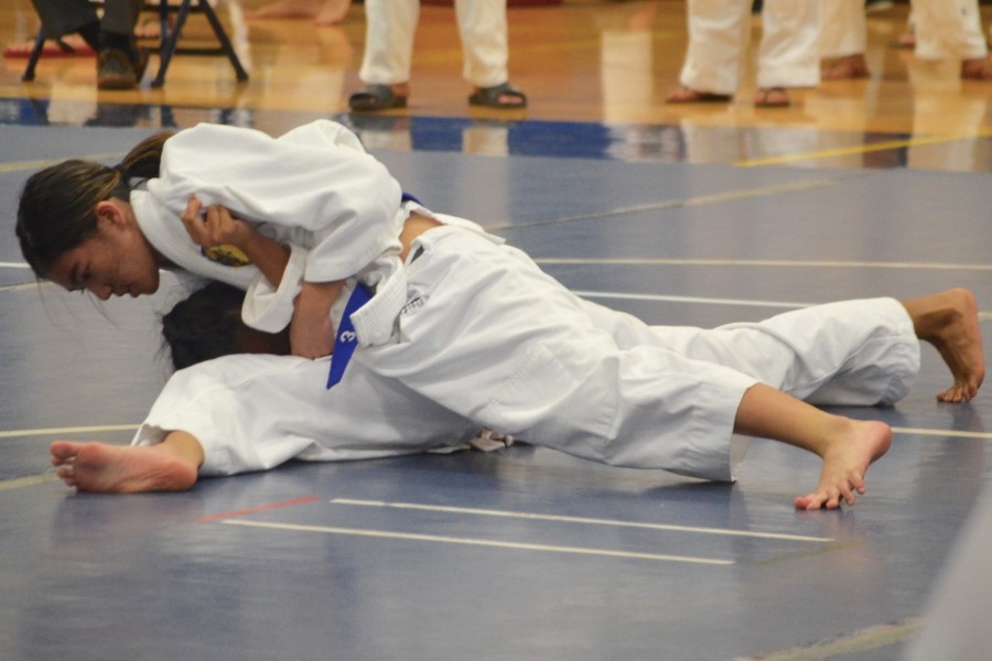 Freshman Jillian Ikehara holds her opponent in place at the opening Round Robin Judo Tournament at Kaʻulaheanuiokamoku Gymnasium on Saturday, April 2. Ikehara placed first in her 98-lb weight class.