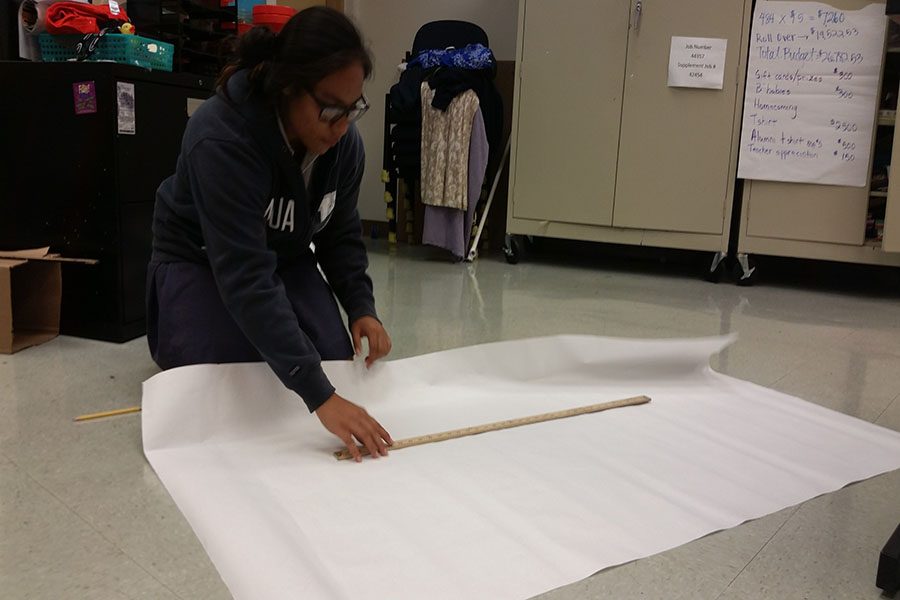 Vice-president Keahinuinakeakua Johnson lays out the artwork for a poster promoting the Life Skills Club for club sign-ups coming up Tuesday, August 30. The Life Skills Club would like to provide opportunities for students to learn and apply skills they will need after graduating high school.