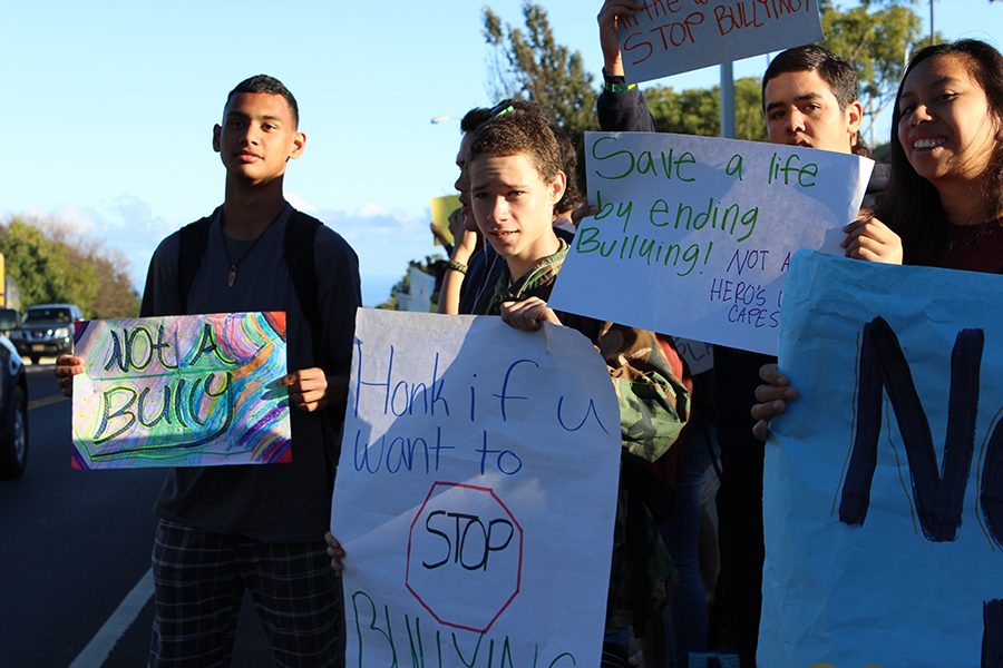 King+Kekaulike+High+School+students+hold+signs+along+the+road+during+a+bullying+awareness+event.