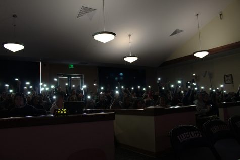The juniors show class spirit by waving their cellphone lights back and forth during their song.