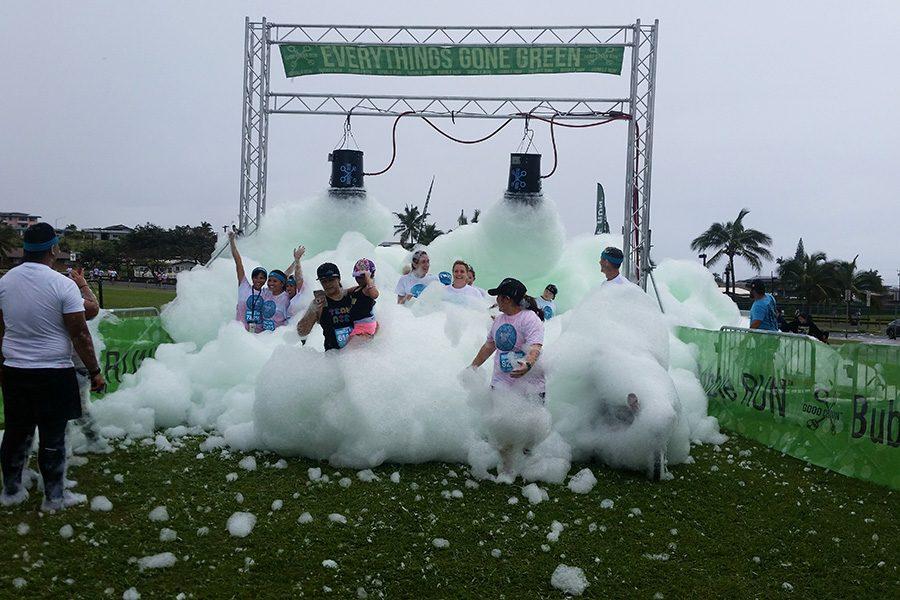 Green foam pours over runners at the Maui Bubble Run, Feb. 11, in Kahului.