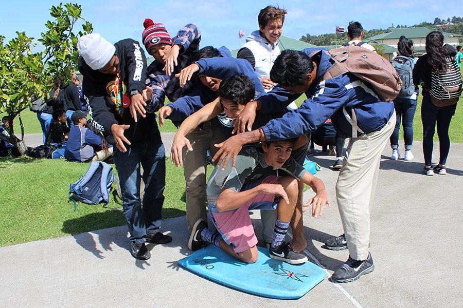 Juniors form a barrel over Kahiau Luat-Hueu who is dressed as a bodyboarder on Tuesday, Sports Day. Spirit week was filled with many dress-up days.