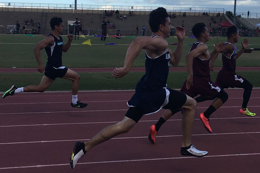 Junior Spencer Keanini competes in the boys 100-meter dash in the 5th track and field meet last night. Teammates and many family and friends cheered the athletes on as they ran. A few of the Warriors made the top eight in their event and competed in Saturdays finals as well.