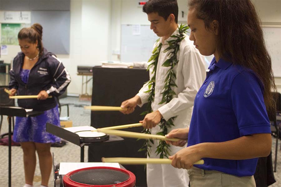 Sophomores Analicia Kapua, Christian Niles and freshman Tatiana Soon practice a drum beat Wednesday afternoon, April 12, in the High School Band Room with Ms. Kim and Mr. Jones. The Drumline had their first meeting with set practice schedules and audition dates.