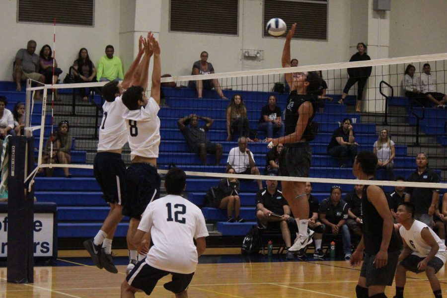 Seniors Hanalei Hoopai-Sylva and Keahi Jacintho jump for a block against Nā Aliʻi. The Warriors got their first win in four years against Nā Aliʻi, Saturday, April 15, at their home gym.