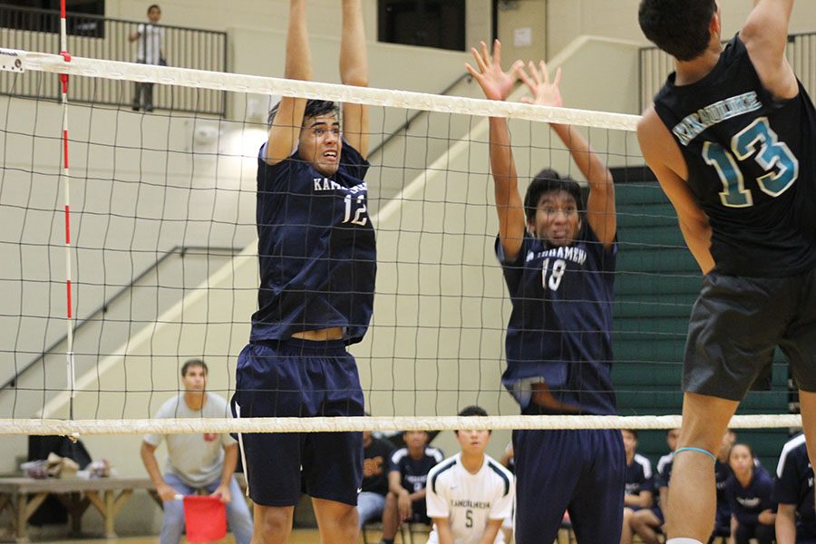 Senior Hāweo Johnson and junior Rafael Adolpho jump to block a King Kekaulike hitter in their last MIL season game, Thursday, April 20. The bleachers at King Kekaulike gymnasium were full with supporters for both schools. Nā Aliʻi came out with the win to end their season 11-1, and the Warriors finished 9-3