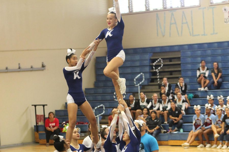 Kaelyn Kato and Kalia Franco balance with confidence in their pyramid stunt.