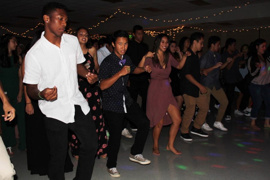 Senior Tyerell Baldando-Kaleiopu leads the dance line. Winter Ball brought all four grade levels together for a night filled with fun before winter break.