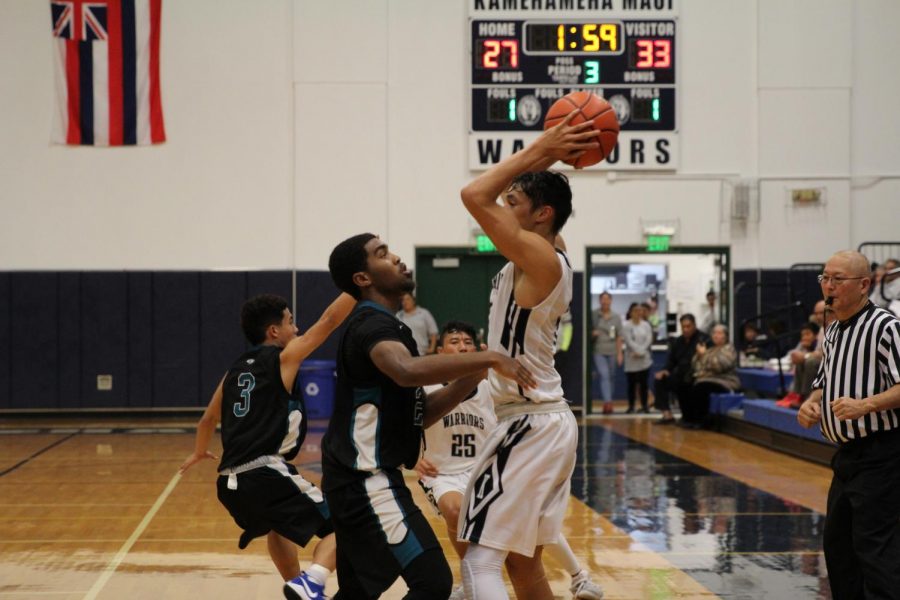 Kapolei junior Jashon Carter guards Junior Kamalu Segundo at the Snapple Boys Basketball Championships, Monday, Feb. 12, at Kaʻulaheanuiokamoku Gym. The Hurricanes won and advanced in the tournament, ending the Maui Warriors journey to the state finals in the first round.
