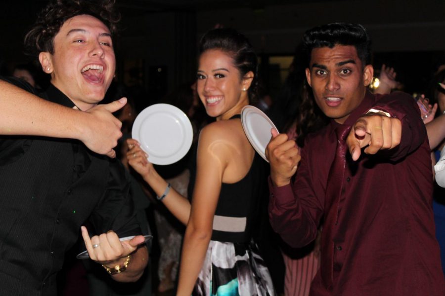 Quinn Warrington, Talia Leauanae, and Michael Singh turn their salad plates into fans as they dance their night away. Ka Papa Lamas senior ball was the schools first masquerade in several years and left students partying in the most glamorous way.