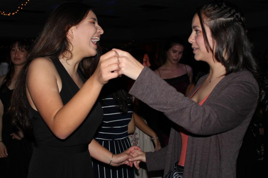 Ali Tavares and Madeline Sylvester laugh with one another while dancing. The freshmen had a great night, Feb. 10, partying like they did in The Great Gatsby, the theme for the night.