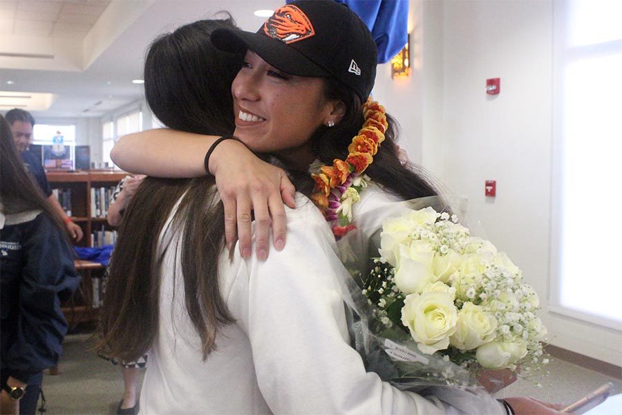 Seniors ʻIlihia Keawekane and Kyana Nagasako hug after Keawekane signed an athletic letter of intent to play soccer for Oregon State University. On Feb. 1, seniors Keawekane and Aliah Ayau signed into West Coast colleges with family and friends supporting their step into a new journey.