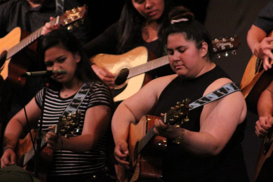 Senior Natalie Warrington plays guitar with the rest of the Guitar 1 class at the spring concert, May 10, in Keōpūolani Hale. The annual concert showcases the work of students in various performing arts classes.