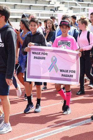 Seventh graders Kekilinahe Ting and Reel Yoshida express gratitude for Pauahi Bishop, the schoolʻs founder who died of breast cancer, at the Walk for Pauahi.