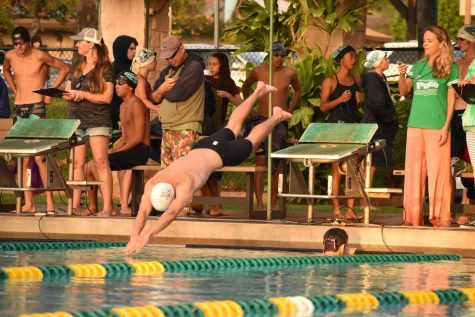 Senior Jonah Miller dives into the pool for the 50-yard freestyle. He ended up placing midfield with a time of 26.44, about four seconds off the lead.
