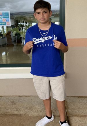 Freshmam Kainoa Gates shows off his Dodgers t-shirt after enjoying a Jamba Juice smoothie outside of the dining hall during flex block.