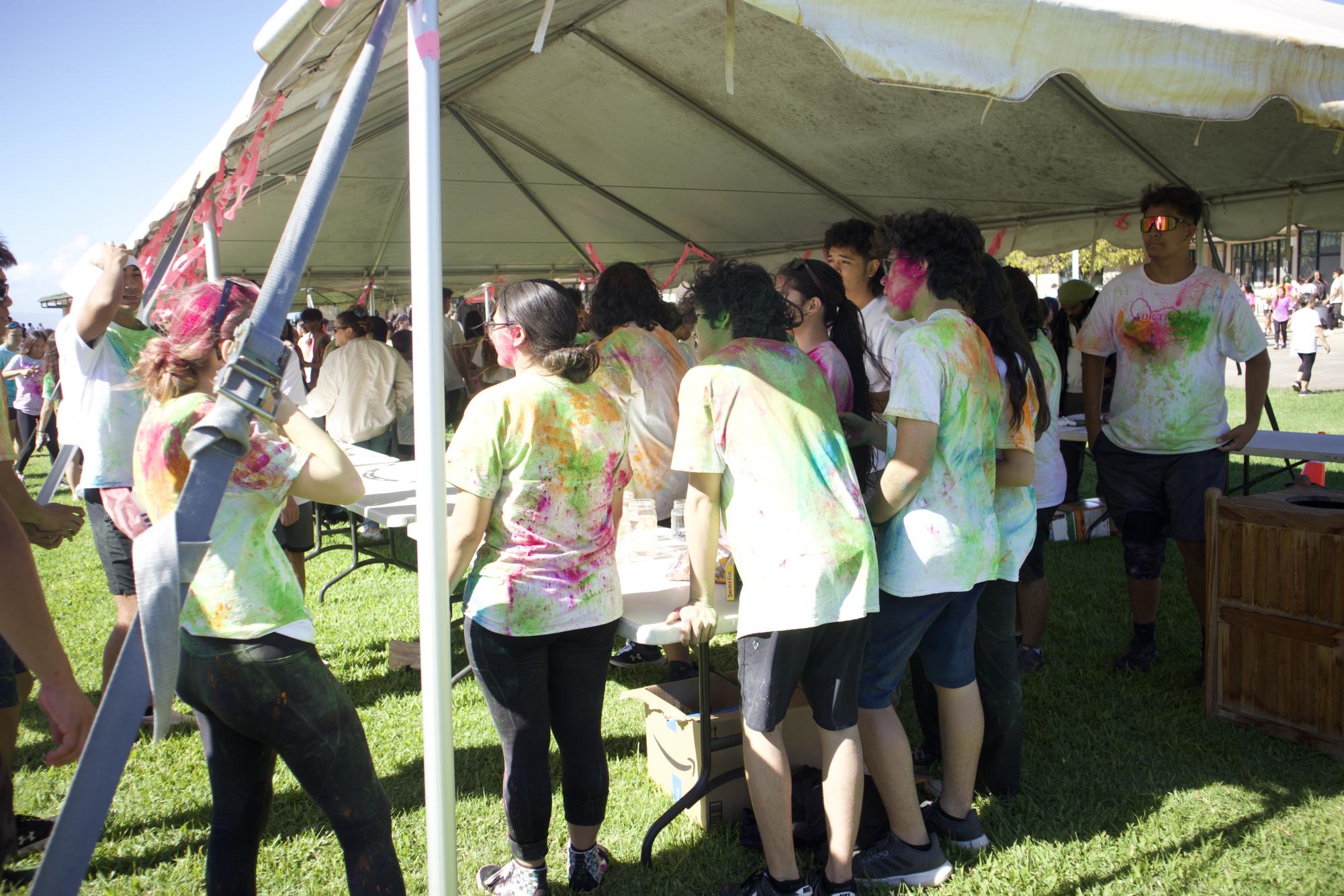 Students gather around the Band booth during the Color Fest to participate in entertaining carnival games.