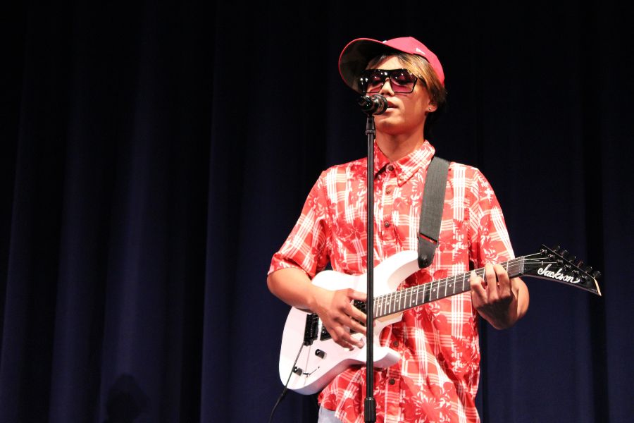Sophomore Zaiyah Madamba Barrozo plays the guitar as part of a Papa Maʻo band at the high school talent show Friday at Keōpūolani Hale. The young band won second place. 