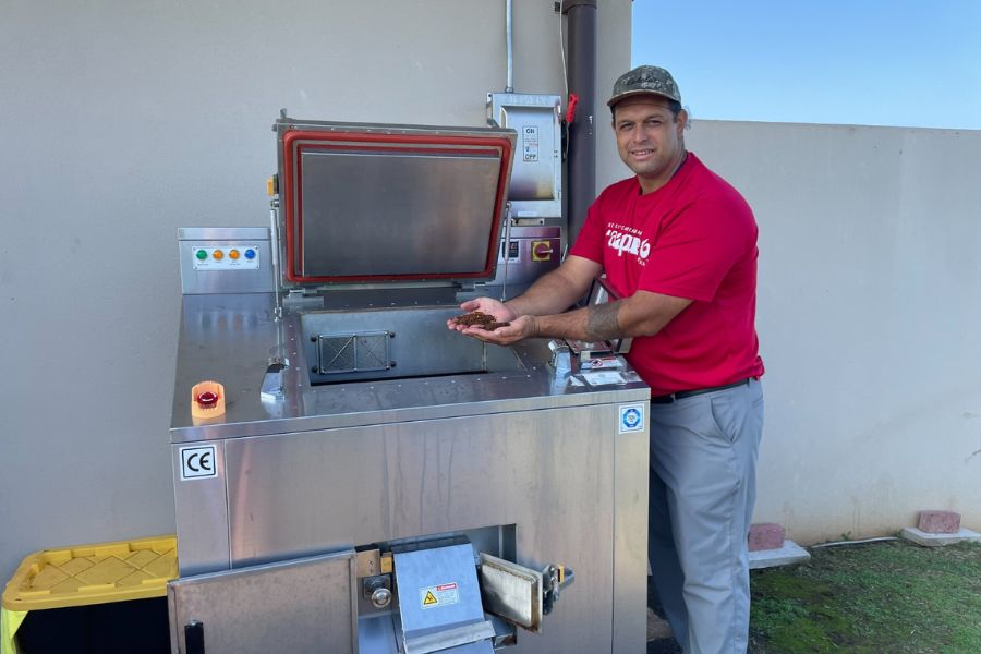 Kumu Iwikauikaua Joaquin, ʻĀina Sustainability teacher for grades 6 to 12, explains how one of three new composting machines on campus are turning food waste into nutritional compost that fertilizes the plants and gardens around KS Maui. "Closing the loop," he calls it. 